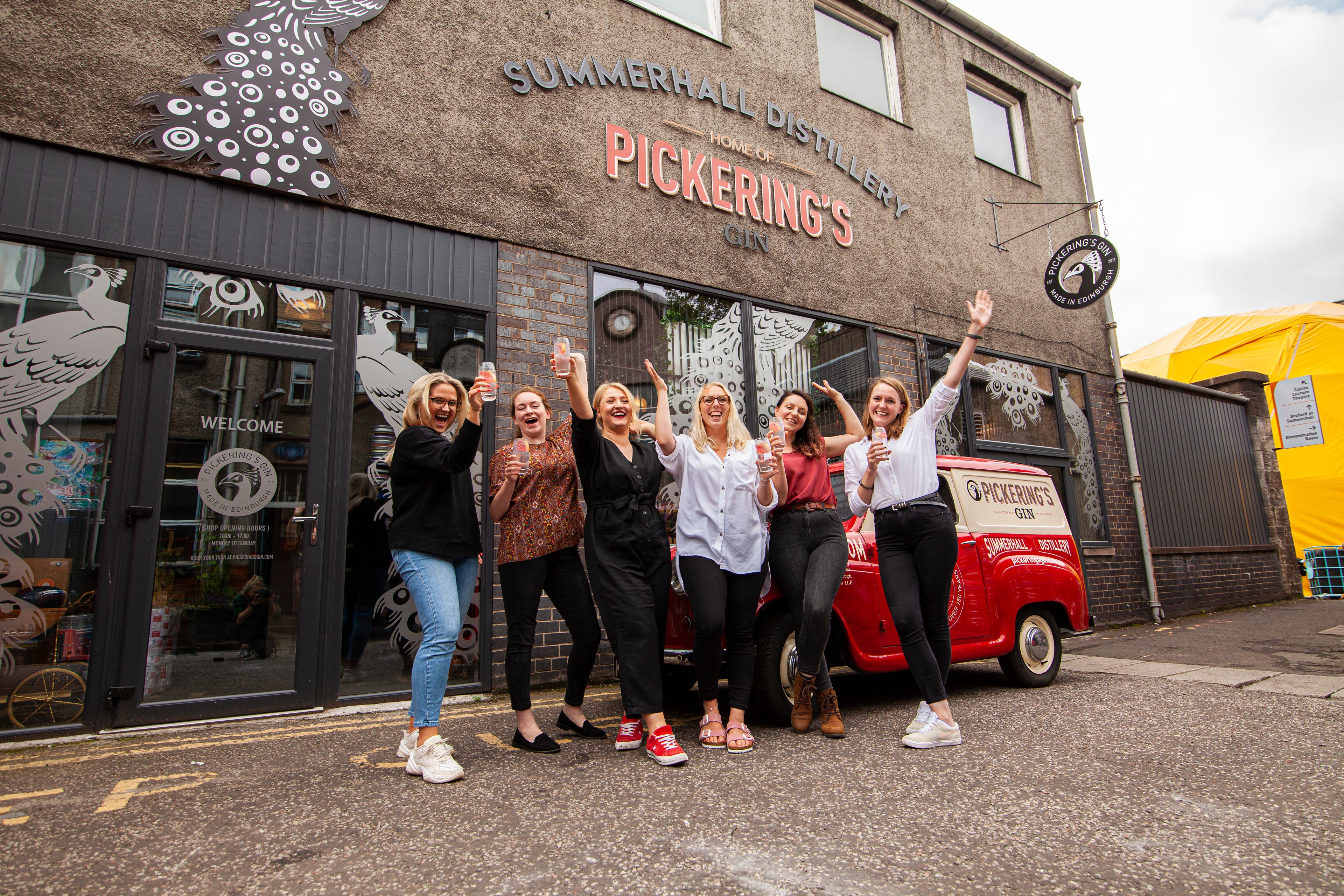 A group of people outside Pickering's Gin distillery