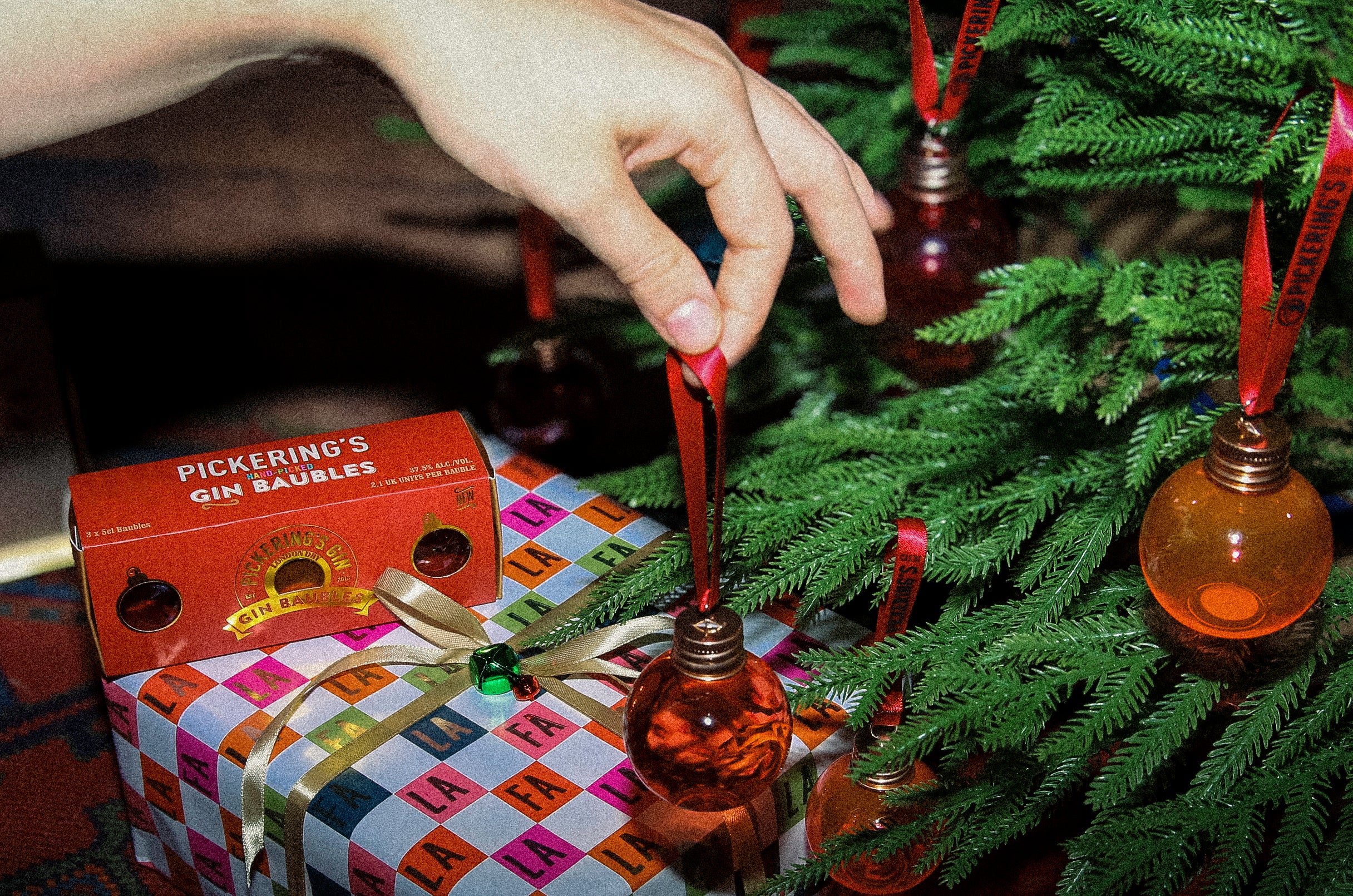 Pickering's Gin Bauble next to a tree